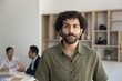 © fizkes - Headshot portrait of inspired young Arabian man starting successful career as intern trainee at international company department. Motivated business staff member looking at camera at workday in office