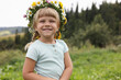 © New Africa - Portrait of smiling little girl in floral wreath outdoors, space for text. Child enjoying beautiful nature