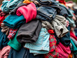 © Artvi - A pile of old used clothing and textiles. Fast fashion and clothing recycling