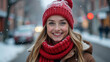 © Georgiy - Beautiful happy young woman in red knitted hat and scarf against winter city background. Banner.