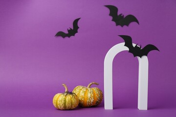 Wall Mural - Presentation of product. Arc and Halloween decor on purple background, space for text