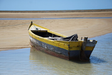 Traditional Fishing Boat Stranded on a Sandy Beach