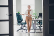 © deagreez - Full size photo of smart elderly chief female point empty space welcome wear formalwear modern office loft room interior indoors workspace