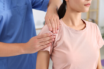 Canvas Print - Physiotherapist working with patient in rehabilitation center, closeup