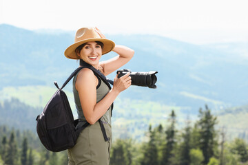 Poster - Photographer with backpack and camera in beautiful mountains