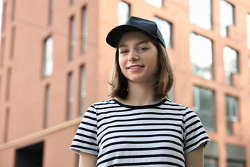 Poster - Portrait of smiling woman in baseball cap outdoors