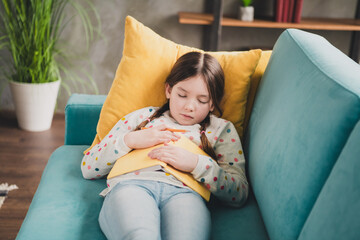 Sticker - Photo of cute small schoolgirl fell asleep book couch wear pullover modern interior apartment indoors