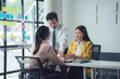 © Kritdanai - Collaborative Brainstorming: A team of Asian professionals, engaged in a dynamic brainstorming session, working together towards a common goal. They are surrounded by sticky notes.