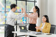 © Kritdanai - High-Five Success: Celebrating Teamwork in Modern Office