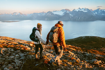 Wall Mural - romantic couple man and woman climbing mountains together active family adventure vacations - friend