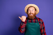 © deagreez - Photo of positive man farmer wear plaid shirt halloween autumn season offer empty space isolated on purple color background