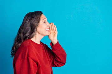 Canvas Print - Portrait of nice aged woman speak empty space wear red sweater isolated on blue color background