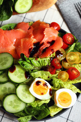 Wall Mural - Fresh salad with cucumber, cherry tomatoes and salted salmon