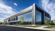 © vladimir - Contemporary office building with large glass windows, surrounded by a landscaped garden, set against a clear blue sky in a suburban environment.