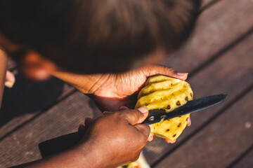 Man Making Unique Pineapple Cuts. Precision and Creativity.