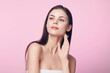 © SHOTPRIME STUDIO - Beautiful young woman with hands on her face against a pink background, skincare concept