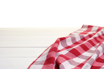 Wall Mural - Crumpled tablecloth with checkered pattern on wooden table against white background