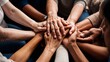© JohnDesignHub - Various hands of different skin tones are stacked showing unity and togetherness in a diverse group.