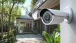 © jinna - Modern Security Camera on Home Exterior Wall