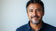 © peppastocker - Close-up portrait of a mature middle-aged man, a freelancer or entrepreneur, isolated on a white background. A smiley, good-looking, 40-year-old Latin Hispanic businessman faces the camera.