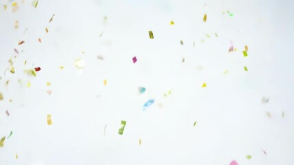 Wall Mural - Bright confetti flying in the air against a white background, representing celebration, joy, and a festive atmosphere. The scene is vibrant and dynamic.