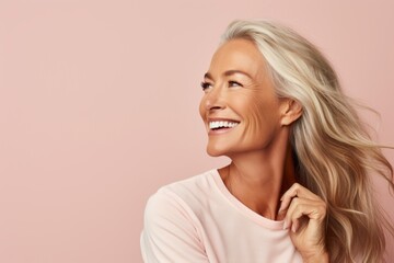 portrait of a happy smiling middle aged woman, over pink background