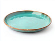 © ekampos - A large glazed turquoise plate on white background