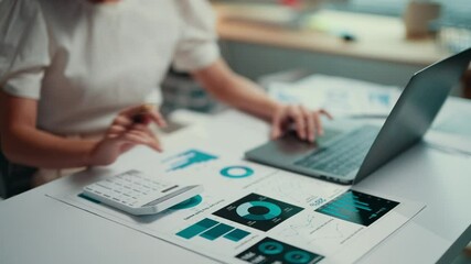 Poster - Businesswoman working on financial data while using a calculator and laptop. Analyzing charts and graphs, she focuses on accounting and strategic planning in a corporate environment