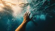 © Ahmed - Underwater vertical shot of a diver reaching toward the surface with one hand