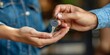 © Iryna - Person handing over a house key to another person as a symbol of ownership or rental agreement
