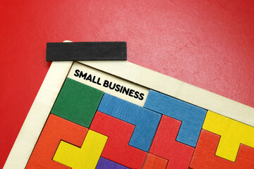 SAMLL BUSINESS  word concept written on wooden puzzle 