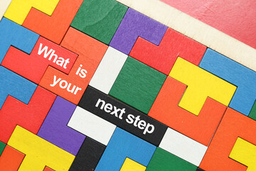 what is your next step word concept written on wooden puzzle