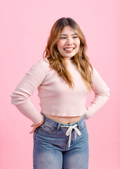 Half body photo cute happy fun young Asian beautiful female, woman smiling in light pink long-sleeve shirt poses isolated plain pastel light over pink color wall background