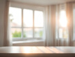 © Nyetock - Blur living room at home with morning sunlight at big window for background usage. blur interior background concept. white, britht tone.