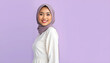 © Azrol - A Muslim Malay Malaysian woman model standing against soft purple background wearing white dress