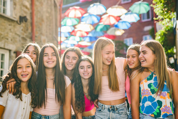 Happy teenagers or childs having fun together on city background