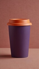 Wall Mural - Purple coffee cup with a pink lid on a pink-orange background.