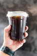 © Dontree - Iced americano in hand. The refreshing moment of enjoying a cold coffee drink