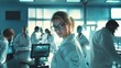 © armensl - Portrait a beautiful young woman wearing a white coat and glasses in a modern Medical Science Laboratory with a team of specialists in the background. Portrait of a confident scientist working.
