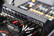 © zphoto83 - Close-up view of audio mixing console with cables connected during a live event setup process
