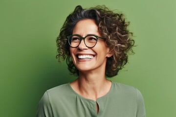 Wall Mural - Portrait of young happy woman with curly hair and eyeglasses