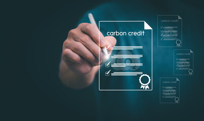 Ideas for reducing carbon emissions or using carbon credits for organizations. Businessman showing carbon credit and green business environmental conservation sustainable environmental development