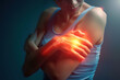 © Infusorian - Close-up of a woman with glowing shoulder, indicating shoulder pain or injury.