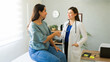 © AntonioDiaz - Female doctor smiling and shaking hands with her hispanic patient after a consultation in her office