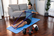 © Summit Art Creations - Athletic and sporty man pulling resistance band exercise during home workout exercise session for fit physique and healthy sport lifestyle at home. Gaiety home exercise workout training concept.
