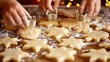 © anantachat - Parents and children baking Christmas cookies together in a warm kitchen rolling dough and using holiday-shaped cutters while wearing matching aprons Large space for text in center Stock Photo with