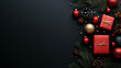 © Bos - A flat lay of Christmas ornaments, pine branches, and gifts on a black background with copy space.