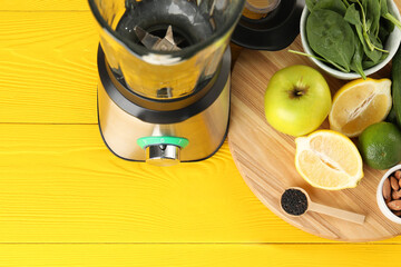 Wall Mural - Modern blender with ingredients for smoothie on yellow wooden table, above view