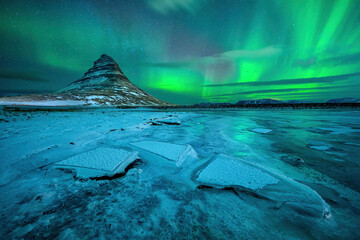 Wall Mural - aurora borealis or northern lights over kirkjufell mountain in iceland
