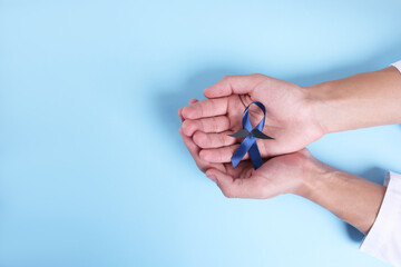 Poster - Prostate cancer awareness. Man with light blue ribbon as symbol of support on color background, top view. Space for text